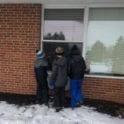 Talking to Regal Heights residents through the window are, from left, Hunter Teague, Dominic Macielag and Leander Teague
