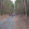 a group of people walking down a dirt road