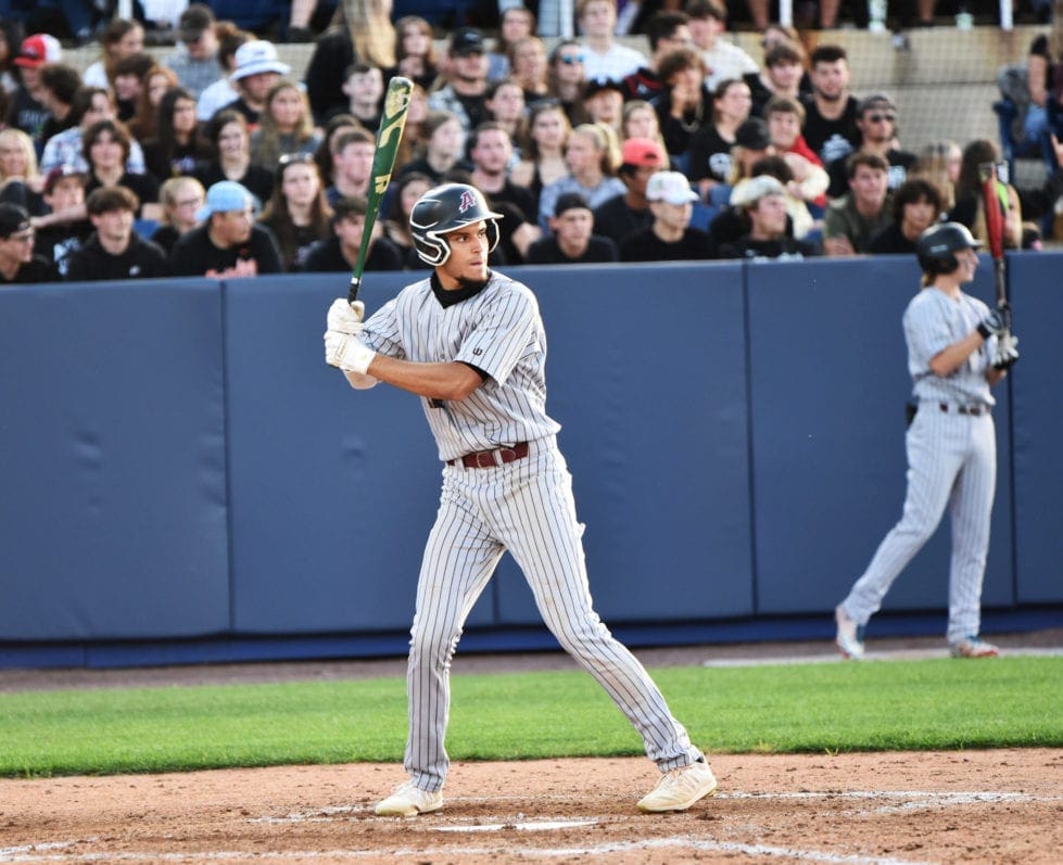 a baseball player swinging a bat at a baseball game