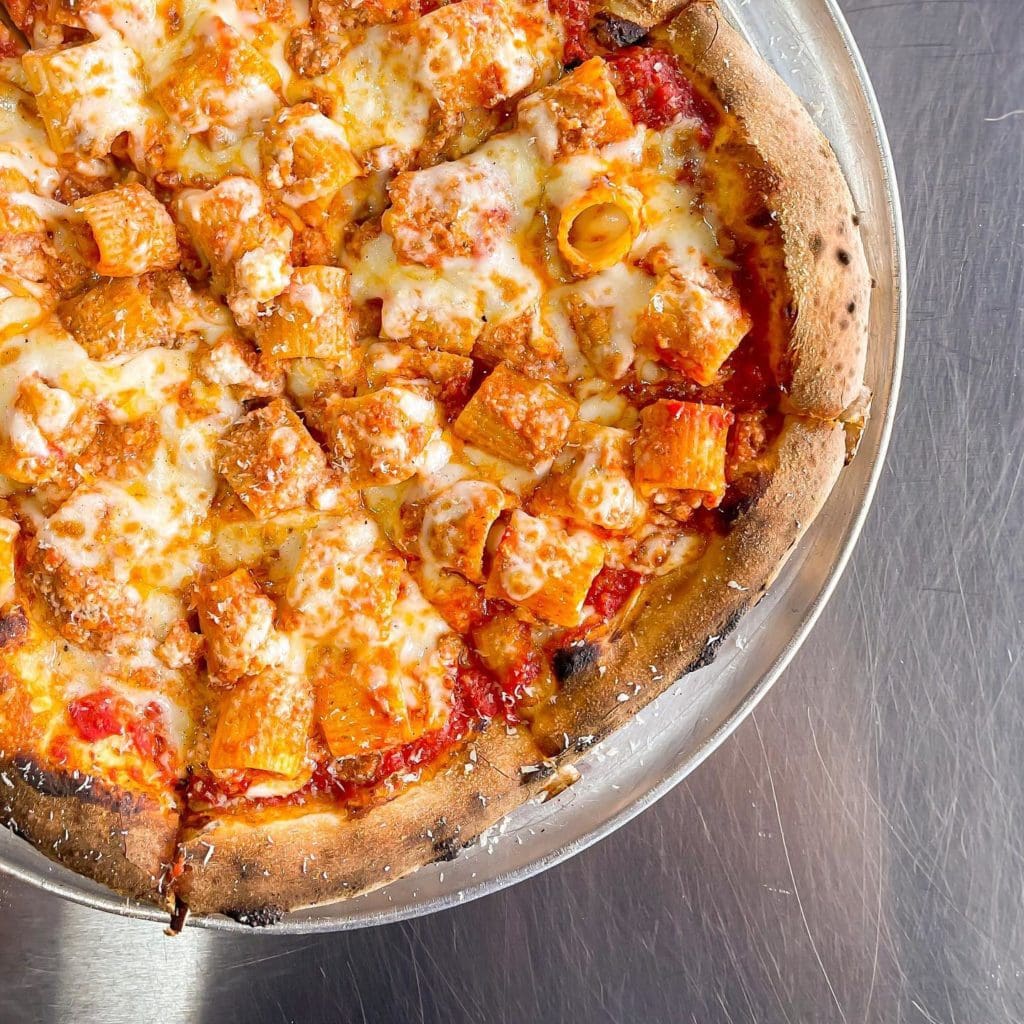 a pizza sitting on top of a metal pan