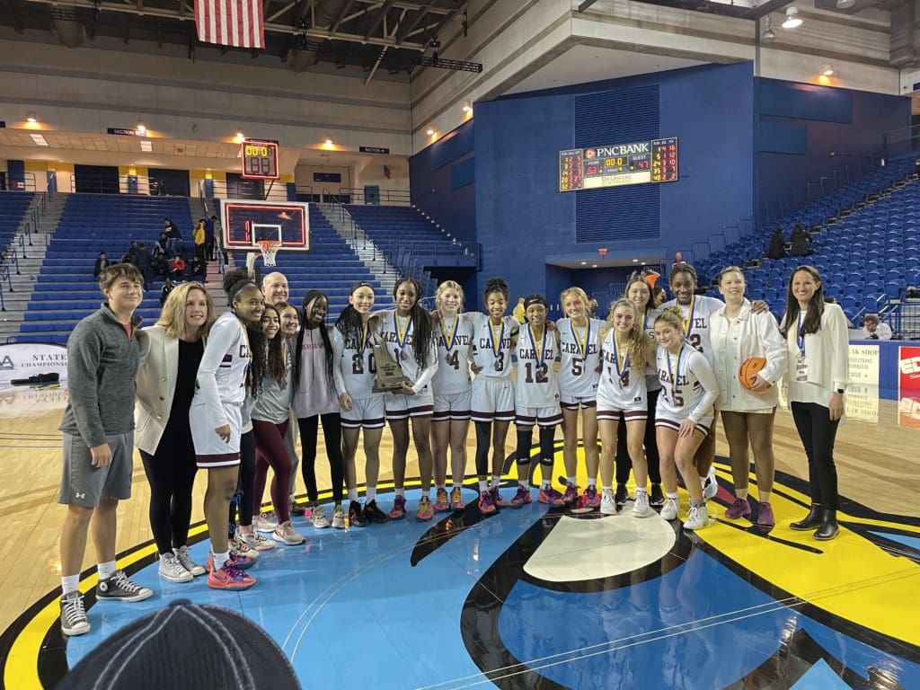 Caravel Girls Baketball team posing wit the State Championship trophy photo by Nick Halliday