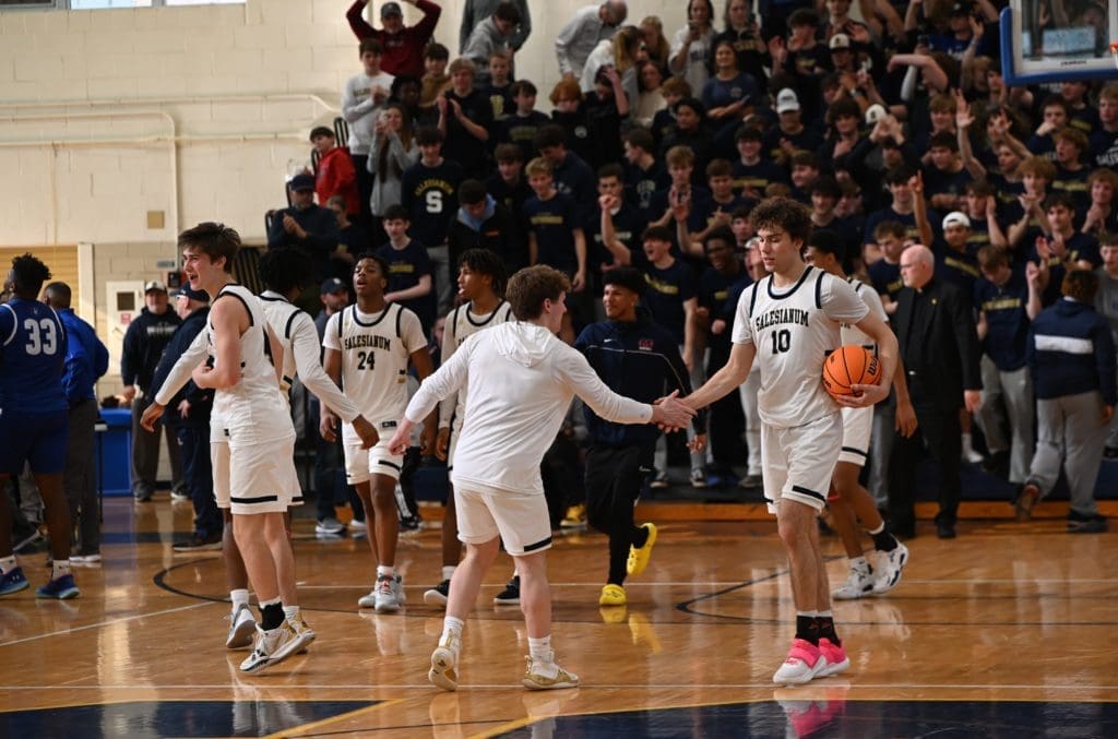 Salesianum boys basketball team celebrates after defeating Dover in the DIAA Quarterfinals