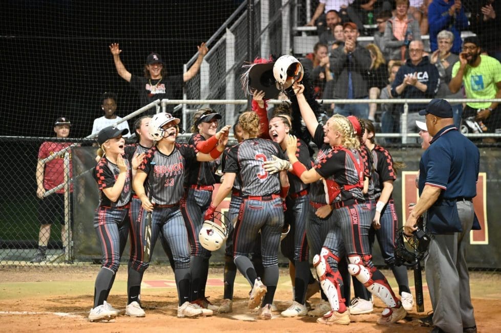 Red Lion softball celebrates at the pate after Peyton Puseys grandslam photo by Nick Halliday scaled 3