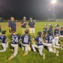 Milton coaches address their players after a thrilling win photo by Benny Mitchell