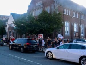 Honks honked in response as Ursuline seniors cheered and waves signs at returning students.