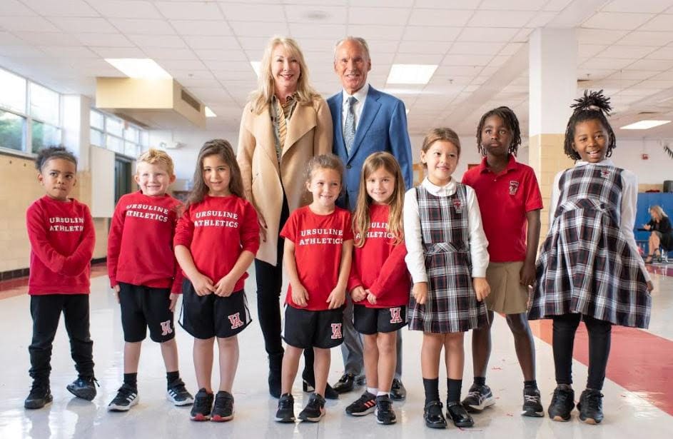 Linda and Paul McConnell with Ursuline Academy Lower School students after announcing a $1.75 million donation to the school. (Ursuline Academy Facebook)