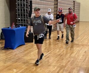 Saint Mark's President Tom Fertal sporting his 20-pound backpack as he jogs around the gym. (Jarek Rutz/Delaware LIVE News)