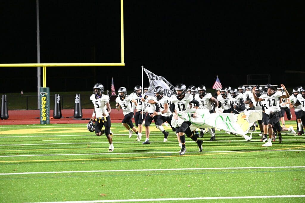 Sussex Tech Football team running out on the field at Odessa photo by Nick Halliday