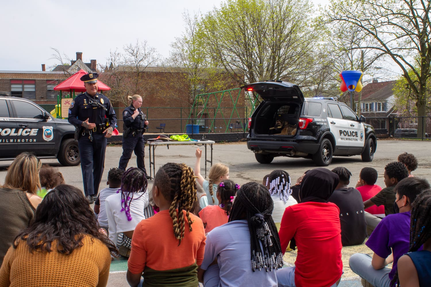Wilmington Police Officers Andrew Conine, left, and Hailey Cockerham giving a K-9 presentation to Highlands Elementary School students in April. (Jarek Rutz/Delaware LIVE News) 