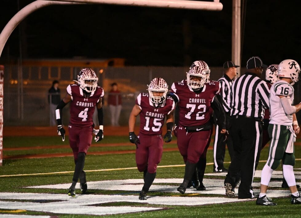 Caravel football players Vandrick Hamlin 4 Jordan Miller 15 and Chase Armstrong 72 run to the sideline after Miller scored the touchdown photo courtesy of Nick Halliday 1