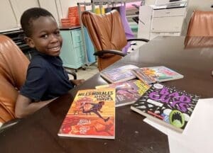 Fourth-grader Kayden Washington with his haul of new books. (Jarek Rutz/Delaware LIVE News)