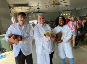 Dawson Raught, Jeffery Brennan and MaKayla Counts with some of the Penn Farm chickens used to harvest eggs.