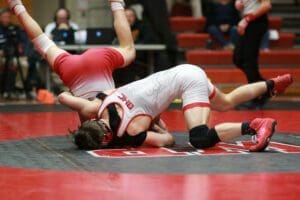 Smyrnas Kyle Davis attempts to roll out of the grasp of Nick Hendricks in their 132 pound match. Hendricks won 7 5. Photo by Pam Lane