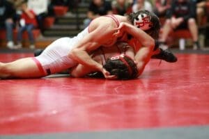 The Colonials Michael Lane starts off the match with a pin over Smyrnas Ricaldo Camacho in 103. Photo by Pam Lane