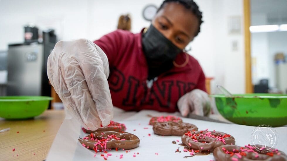A SITE intern working on baking Valentine's Day treats. (Brandywine FaceBook)