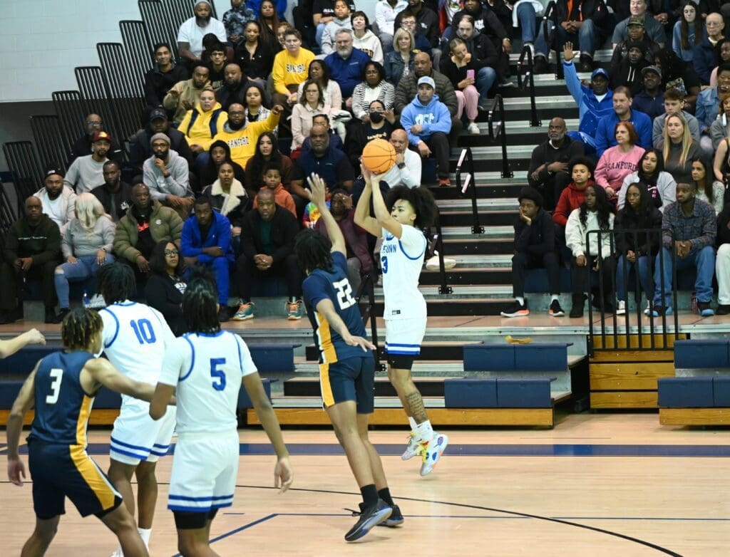 Middletown basketball player Jaiden McGhee shooting a 3 pointer duing the win over Sanford in the DIAA quarterfinals photo by Nick Halliday