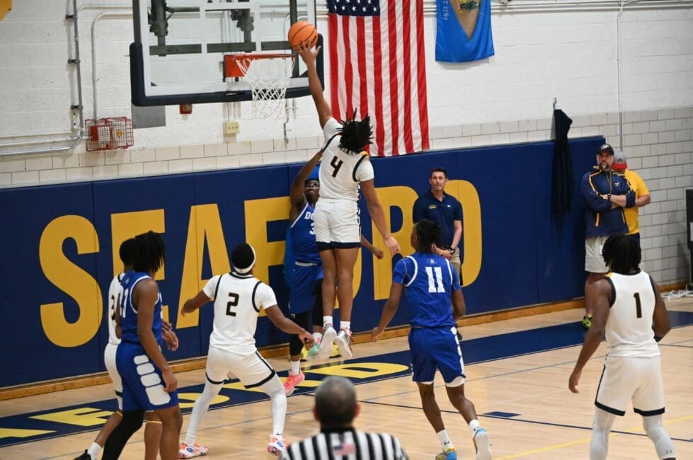 Seaford basektball Aivyon Matthews skies o block a shot during their win over Dover in the DIAA boys basketball state championship photo by Nick Halliday 1