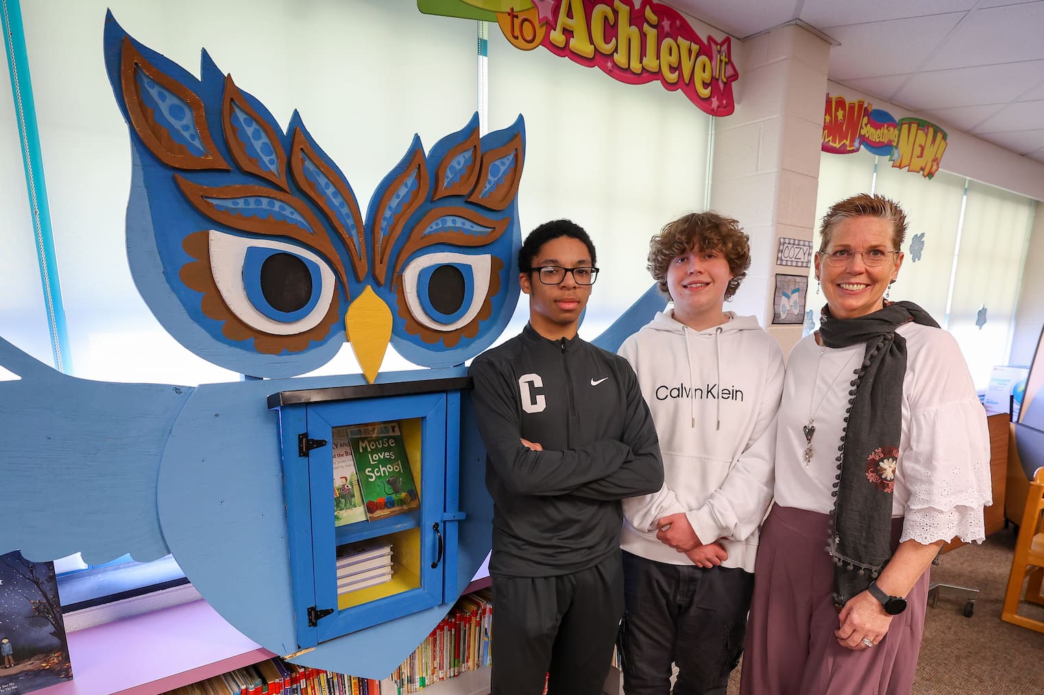Reading specialist Dina P. Evans with the Little Free Library at Maple Lane Elementary, and creators Jalen Caesar and David Ennis. (Brandywine School District)
