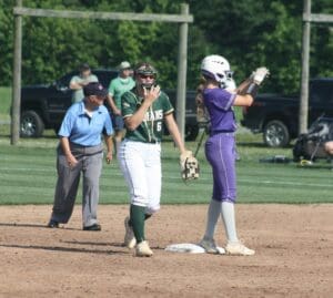 Maggie Kwiatkowski turns and applauds Kaylan Yoder after reaching first photo by Benny Mitchell