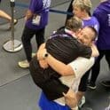 Brian jumping into Coach James arms after winning the medal photo courtesy of Christine and Manny Perry