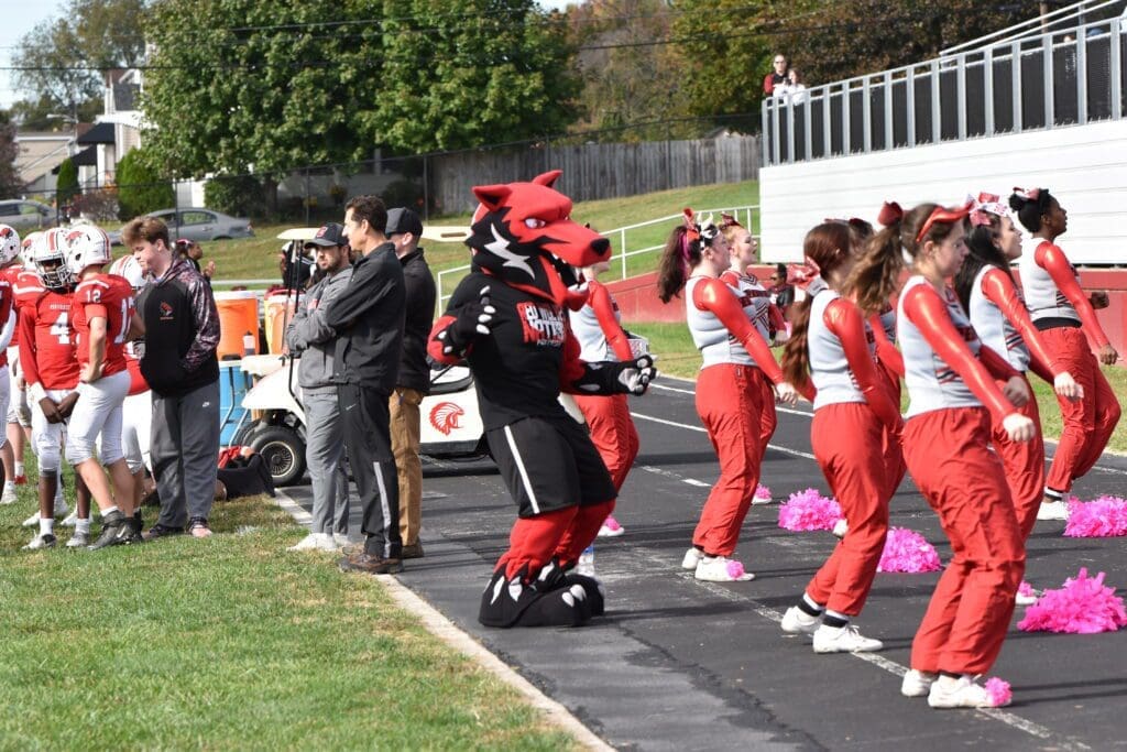Conrad mascot the Red Wolves is cheering with the Red Wolves cheerleaders photo by Nick Halliday