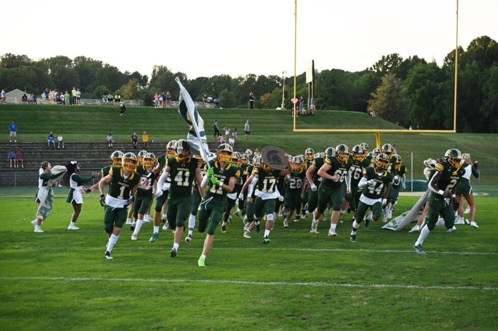 Saint Marks football team running out on the field photo by Nick Halliday