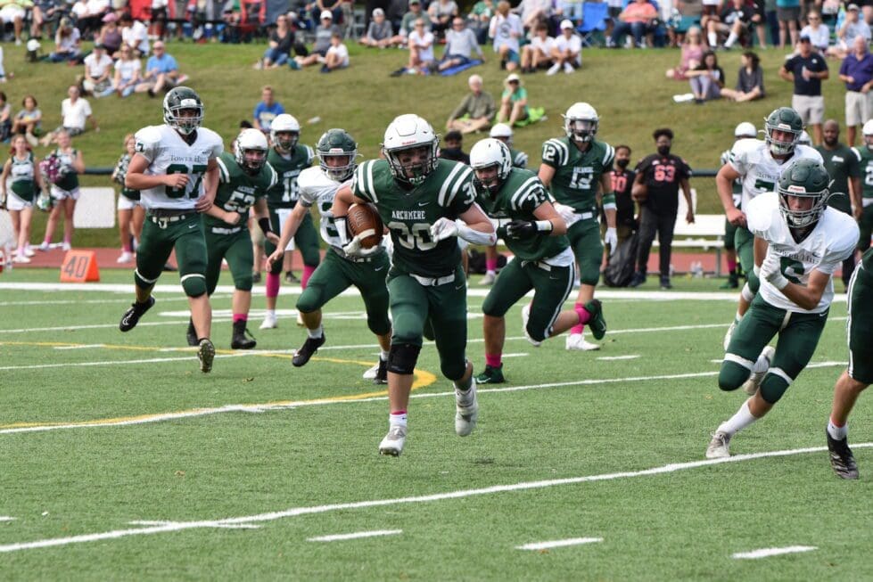 Archmere football player running the bll during a game photo by Nick Halliday