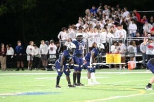 DMA football calling a play and you can see the opponents student section in the background photo courtesy of Nick Halliday