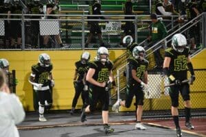 Odessa Ducks football team coming through the stands in the beginning of a game photo courtesy of Nick Halliday