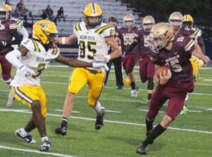 Vikings quarterback Cole Andrews comes face to face with Darnell Stokes of Indian River photo courtesy of Mike Lang