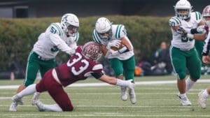 Caravel football Brock Rhoads tackles Archmere football Ryan Hagenberg in the DIAA 2A football state championship photo courtesy of Donnell Henriquez