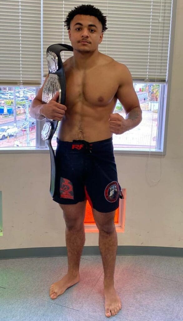 Jevon Saffold poses with his Grasp the Future Amatuer Fight League 145 pound title belt. Photo credit Ryuku Fight Club