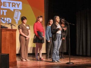 DELAWARE'S 2023 POETRY OUT LOUD WINNER MAISS HUSSEIN ON THE MIC IN LAST YEAR'S FINALS. (JAREK RUTZ/DELAWARE LIVE NEWS)