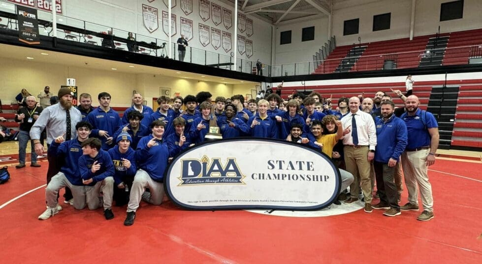 Sussex Central Division I wrestling state champions posing with the state championship trophy photo courtesy of Sussex Central Facebook