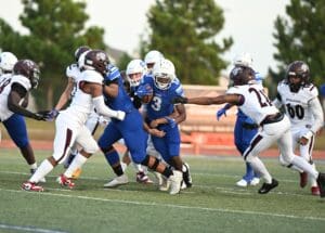 Dover football Nehemiah Coston tries to run the ball but is surrunded by Appoquimink defenders. Photo by Ben Fulton