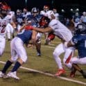Josiah Torres left and Ian Nance right bring down Chris Trumbull of Red Lion. Photo by DarJuan Pitts