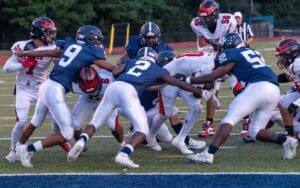 Lake Forest defenders Andrew White 2 and RaeKwon Sullivan 52 stop Red Lion running back Mehki Corbin short of the endzone. Photo by DarJuan Pitts