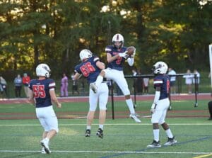 Newark Charter football MAxwell Wiest 3 celebrates with his teammates after a touchdown. Photo by Nick Halliday