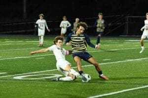 Caesar Rondey soccer Trevor Sullivan attempts a slide tackle on Salesianum Tyler Cifa. Photo by Nick Halliday