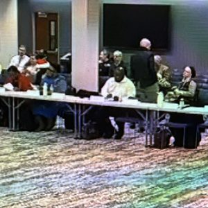 Redding Consortium members meeting around a U-shaped table.
